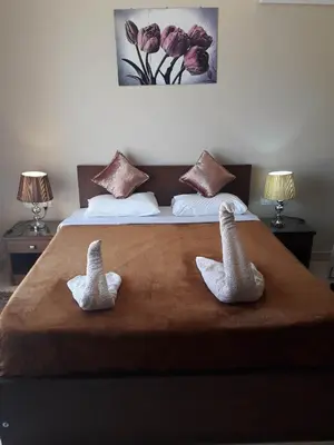 two swans made out of towels sitting on a bed at luxury apartment at Mangroovy El Gouna in Hurghada