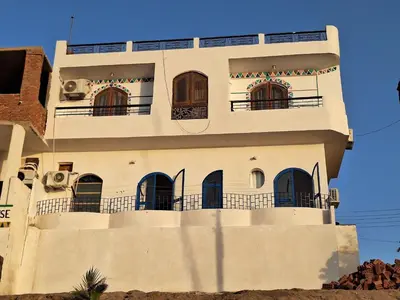 a white building with balconies on top of it at NOBATiA Guest House in Aswan