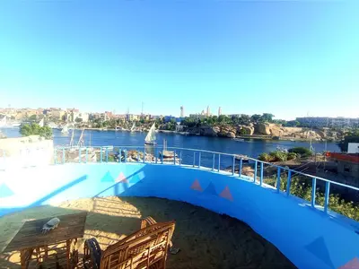 a balcony with a view of a river at Winji Guest house in Aswan