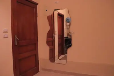 a mirror on a wall next to a door at Studio Lotus compound near Touristic Mamsha in Hurghada