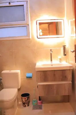 a bathroom with a sink and a toilet and a mirror at Studio Lotus compound near Touristic Mamsha in Hurghada