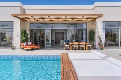 a villa with a swimming pool and a house at Steigenberger Resort Ras Soma in Hurghada
