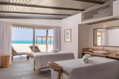 a room with two beds and a view of the beach at Steigenberger Resort Ras Soma in Hurghada