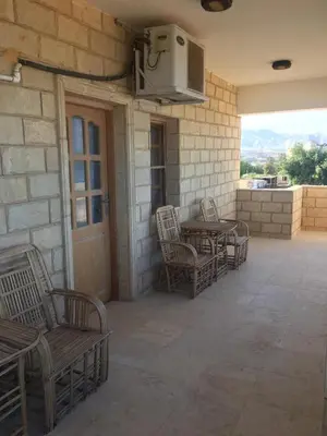a patio with chairs and a table and a microwave at Coral Paradise Villa in Safaga