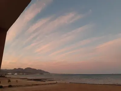 a view of the beach at sunset at Coral Paradise Villa in Safaga