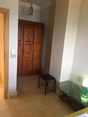 a room with a glass table and a wooden door at Coral Paradise Villa in Safaga