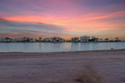 a body of water with buildings in the background at Joubal 3BR Villa Private Pool next to Marina in Hurghada