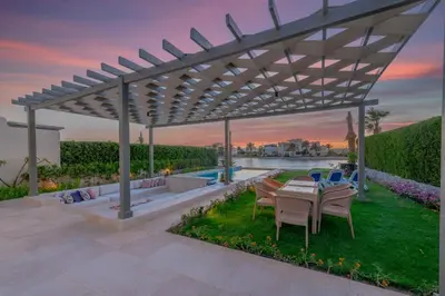 a pergola over a patio with a table and chairs at Joubal 3BR Villa Private Pool next to Marina in Hurghada