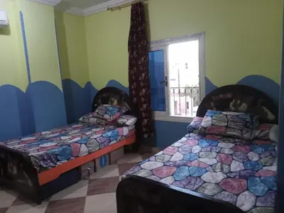 a bedroom with two beds and a window at IKEA Flats in Hurghada