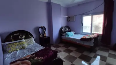 a room with two beds and a window at IKEA Flats in Hurghada