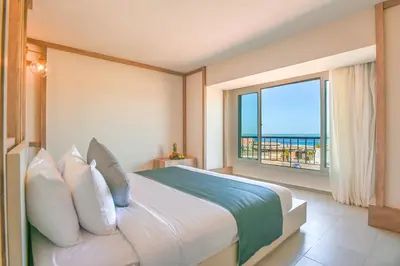 a bedroom with a bed with a view of the ocean at AJIRA Boutique Hotel Hurghada Marina in Hurghada