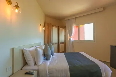 a bedroom with a bed with pillows and a window at AJIRA Boutique Hotel Hurghada Marina in Hurghada