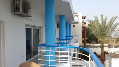 a balcony with blue pipes on a building at Hofni Palace Nile Niew in Luxor