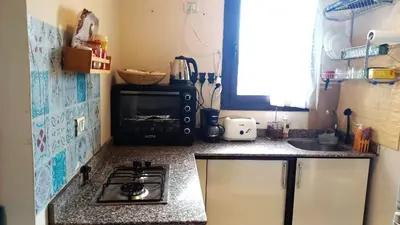 a small kitchen with a stove and a sink at Chalet at Stella Makadi Beach in Hurghada