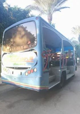 a blue bus is parked on a street at Chalet at Stella Makadi Beach in Hurghada