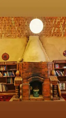 a living room with a brick fireplace with a ceiling at Scorpion House Luxor in Luxor