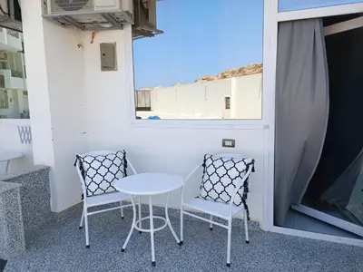 two chairs and a table on a balcony at Studio beside El Gouna with good kite spot in 500 m in Hurghada