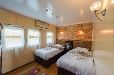 a room with two beds in a train at Dahabiya ECO Queen Cleopatra in Esna
