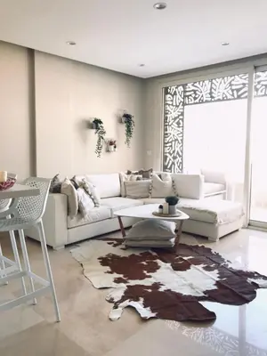 a living room with a couch and a table at Jutta Deluxe 2-Bedroom-Apartment Mangroovy-M7 El Gouna in Hurghada