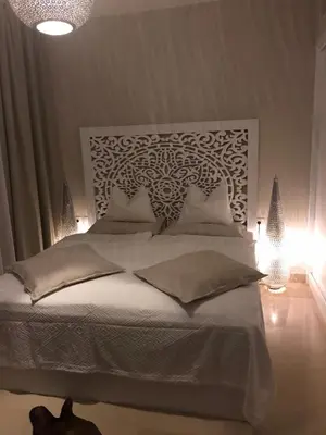 a bedroom with a large white bed with lights at Jutta Deluxe 2-Bedroom-Apartment Mangroovy-M7 El Gouna in Hurghada