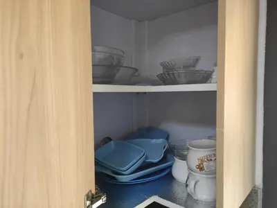 a cupboard filled with bowls and other dishes at Full Apartment with Panoramic View of Hurghada in Hurghada