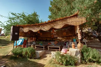 an outdoor shelter with a couch and a table at Krouma Camp & Ecolodge in Aswan