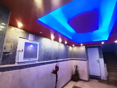 a room with a blue ceiling and a tv at Mama Africa in Hurghada