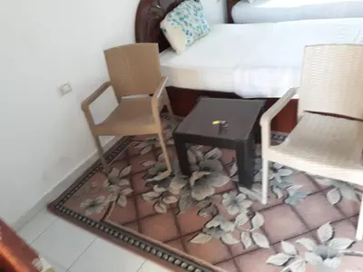 a room with two chairs and a table and a bed at Mama Africa in Hurghada