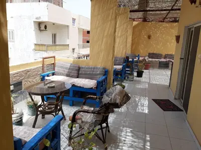 a patio with a table and chairs and a table at Mama Africa in Hurghada