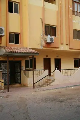 a building with a staircase in front of it at apartment with separate entrance near Arabia hotel in Hurghada