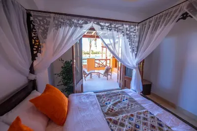 a room with a bed and a window with curtains at Charming Lagoon Villa with pool Egyptian Style -Sabina 117 in Hurghada