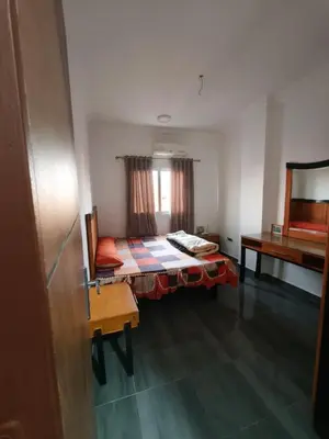 a small room with a bed and a table at Rhein in Hurghada