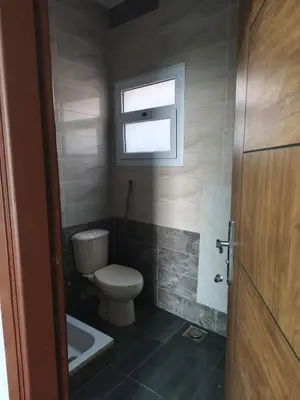 a small bathroom with a toilet and a window at Rhein in Hurghada