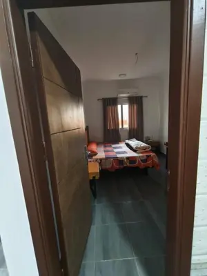 a room with a bed and a table in a room at Rhein in Hurghada