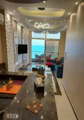 a living room with a view of the ocean at Rony's Ocean View Family Apartment in Hurghada