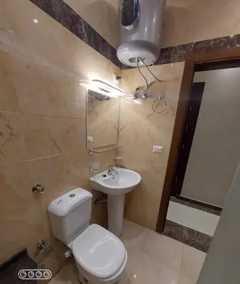 a bathroom with a toilet and a sink at Rony's Ocean View Family Apartment in Hurghada