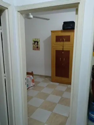 a room with a cabinet and a tiled floor at Bob Marley Homestay in Hurghada