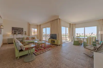 a living room with a couch and a tv at VESTA - Soma Bay Residence in Hurghada