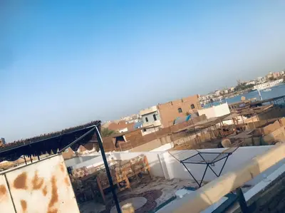 a view of a building with the ocean in the background at Tara Apartments in Luxor