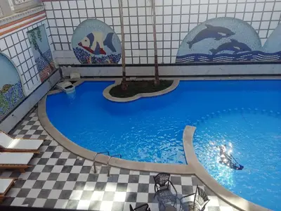 a large swimming pool in a building with a swimming pool at apartman Marek in Hurghada