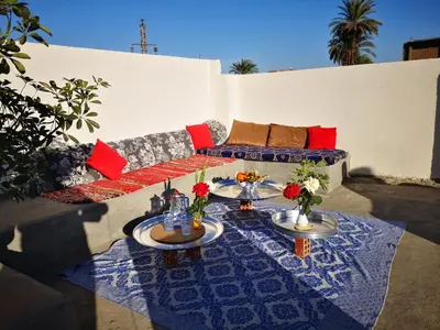 a living room with a couch and two tables at Sinderella Private Pool Villa in Luxor