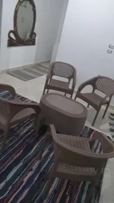 a living room with two chairs and a mirror at Shipa Nubian Guest House in Aswan