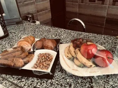 a table with a bunch of different types of bread and fruit at Shipa Nubian Guest House in Aswan