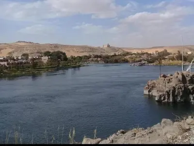 a view of a river with a town in the background at Shipa Nubian Guest House in Aswan