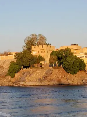 a building on an island in the water at Shipa Nubian Guest House in Aswan