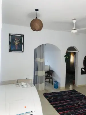a living room with a bed and a table at Shipa Nubian Guest House in Aswan