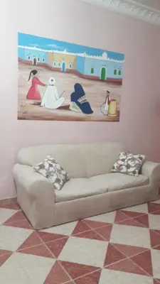 a couch in a living room with a painting on the wall at Villa Diletta Luxor in Luxor