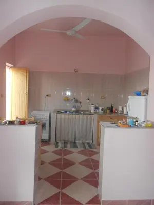 a kitchen with an archway in the middle of it at Villa Diletta Luxor in Luxor