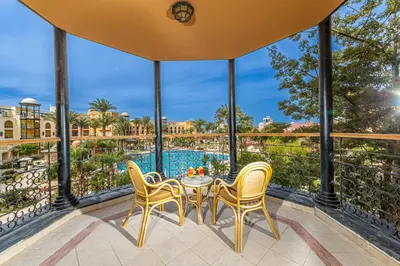 a table and chairs on the balcony of a resort at The Grand Resort in Hurghada