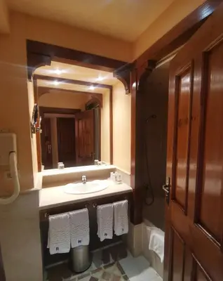 a bathroom with a sink and a mirror at The Grand Resort in Hurghada